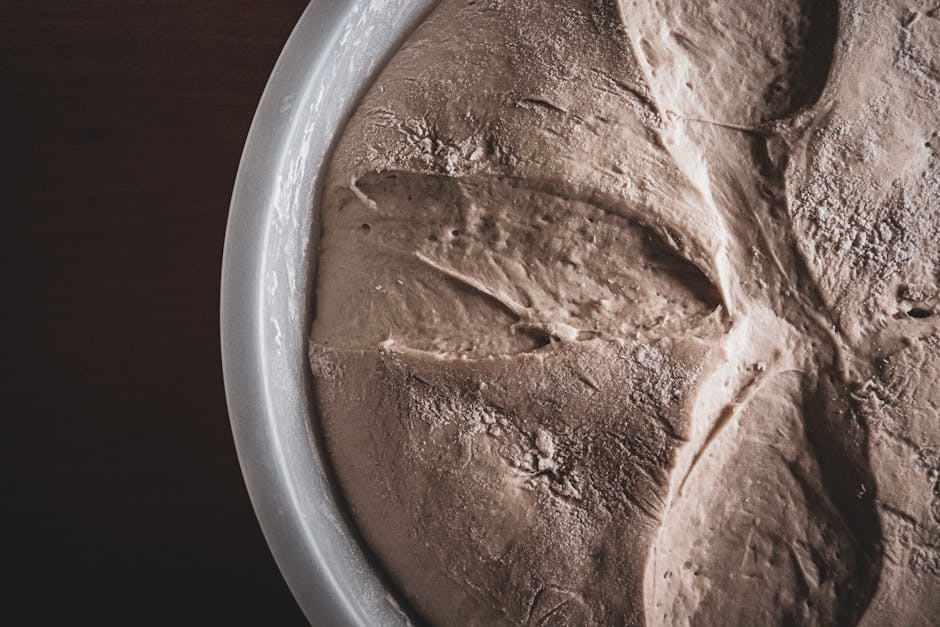 A close-up view of dry, cracked dough in a bowl showcasing unique textures and patterns.