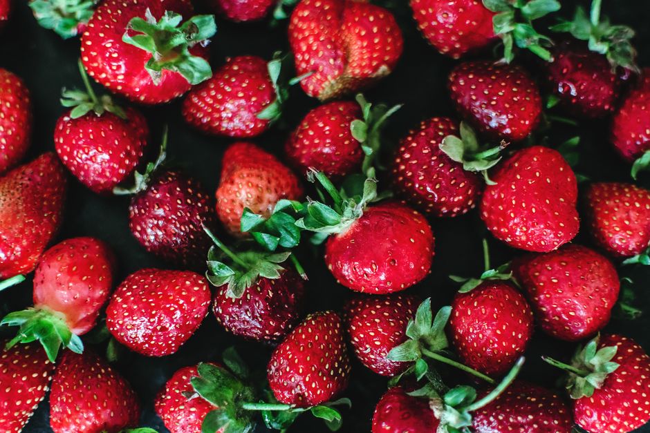 Vibrant fresh red strawberries showcasing texture and freshness in a close-up shot.