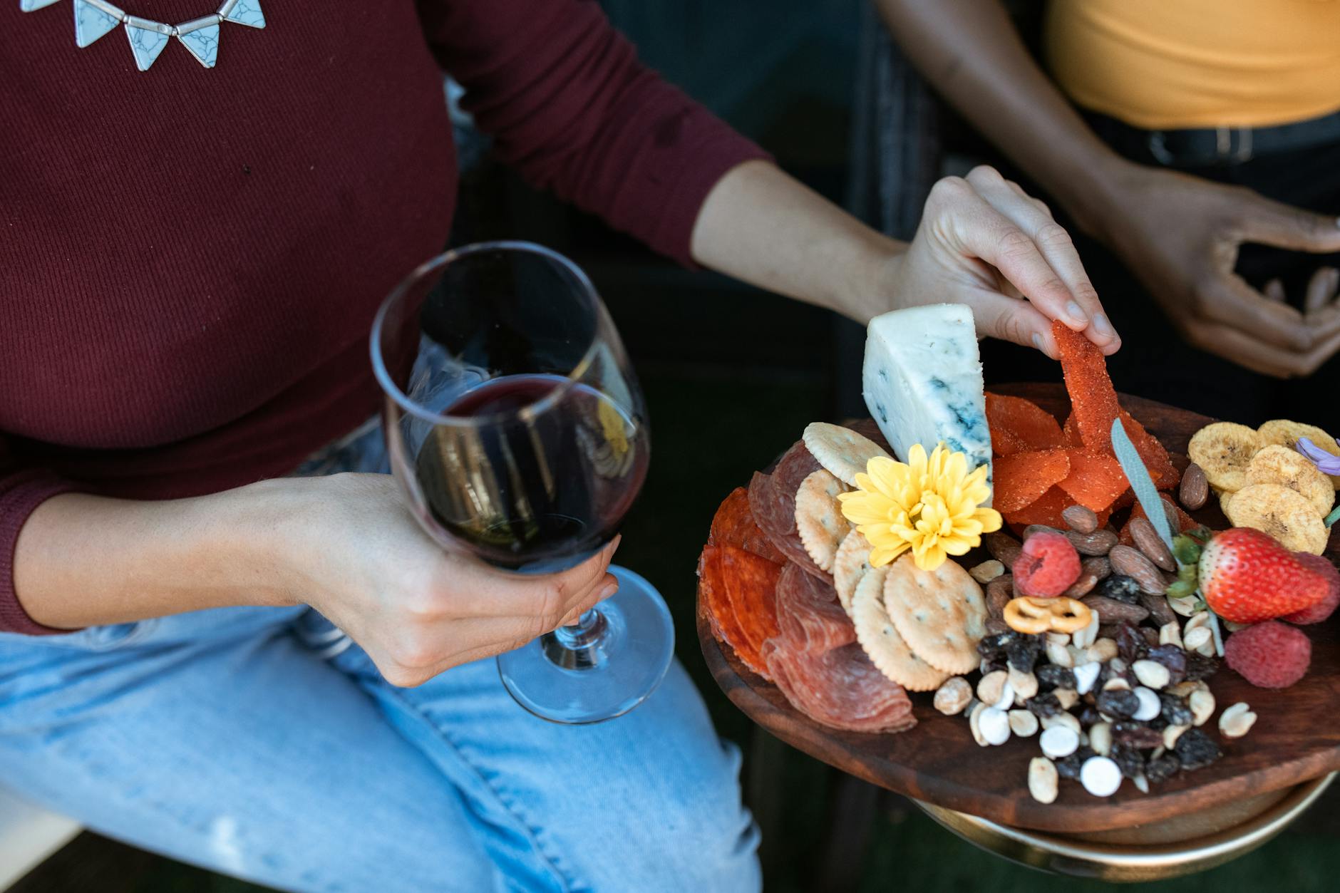 Close-up of charcuterie board and wine pairing for a cozy gathering.